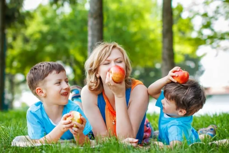 lifegiving homeschooling family eating apples on a nature walk